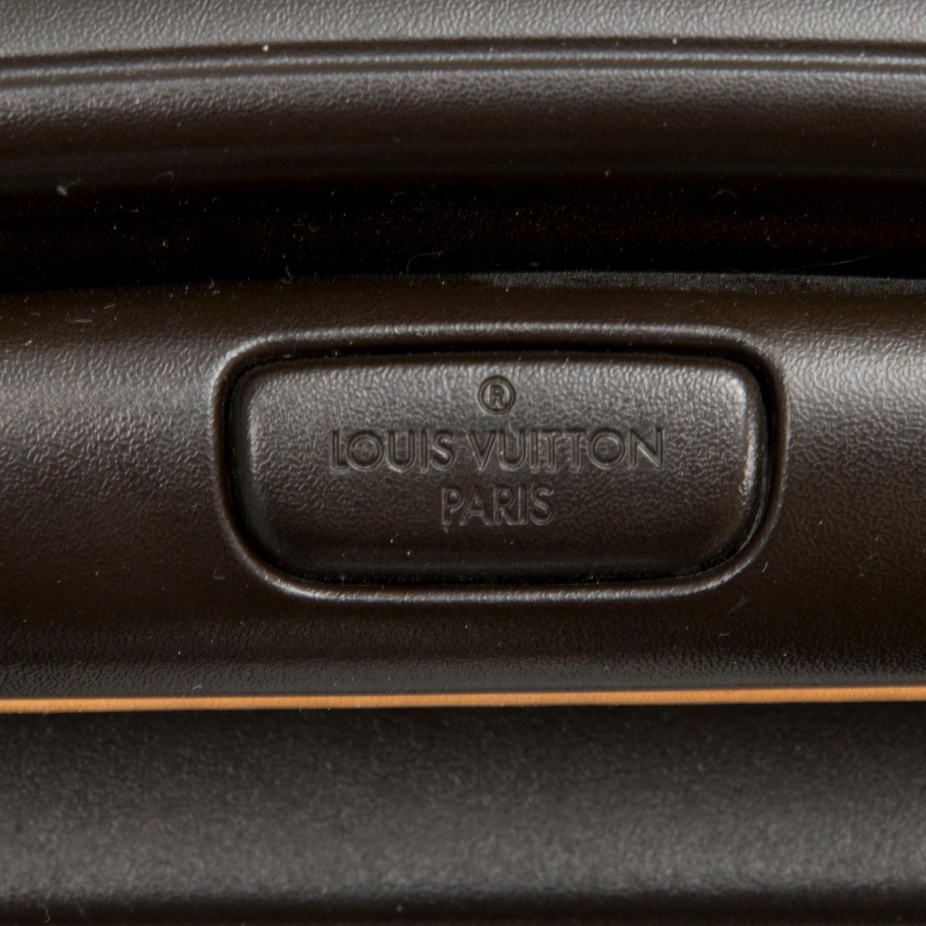 A Monogram Canvas Pégase 65 Suitcase with a Protective Cover.