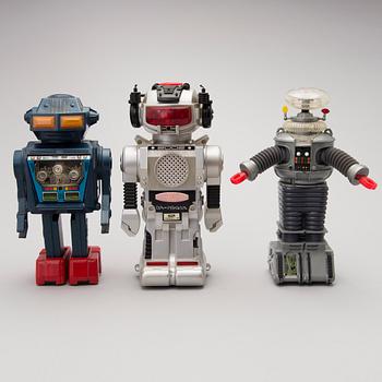 Three Vintage Toy Robots and a Table Clock.