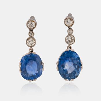 A pair of 18K white gold earrings set with faceted sapphires and old-cut diamonds.