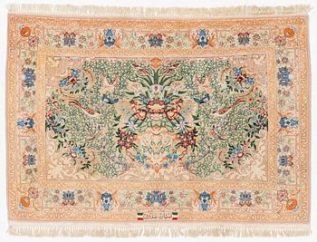 An Esfahan rug, part silk, figural, signed, c. 108 x 155 cm.