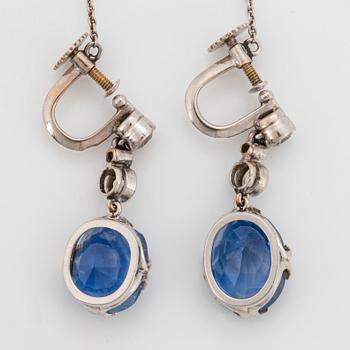 A pair of 18K white gold earrings set with faceted sapphires and old-cut diamonds.