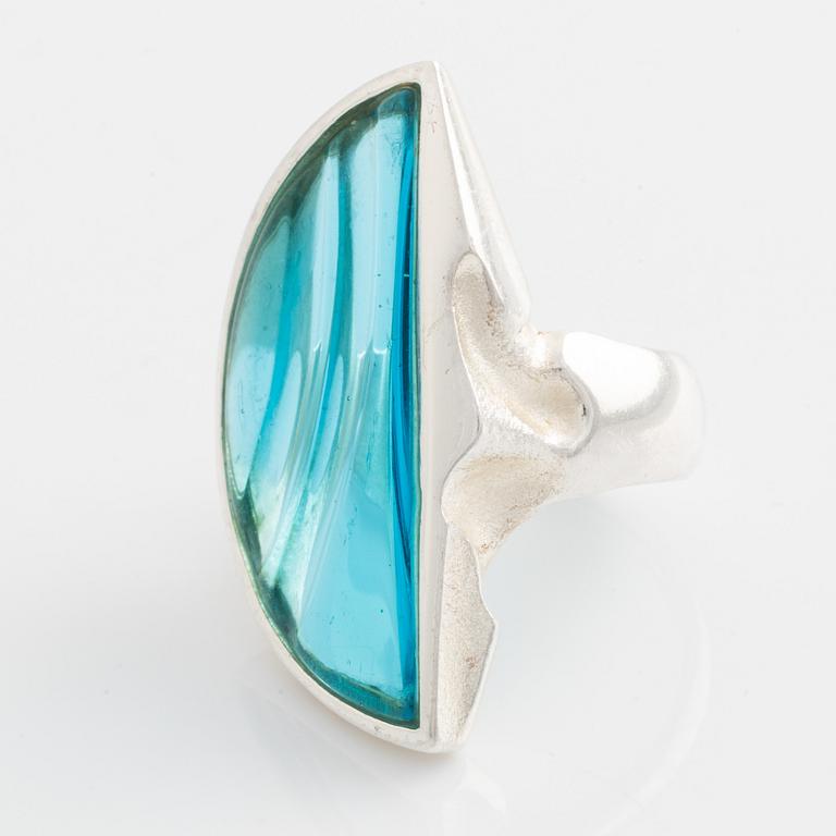 A Lapponia silver ring set with blue glass.