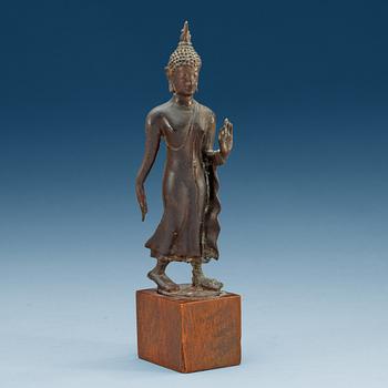 1864. A walking Thai bronze figure of buddha, 19th Century or older.
