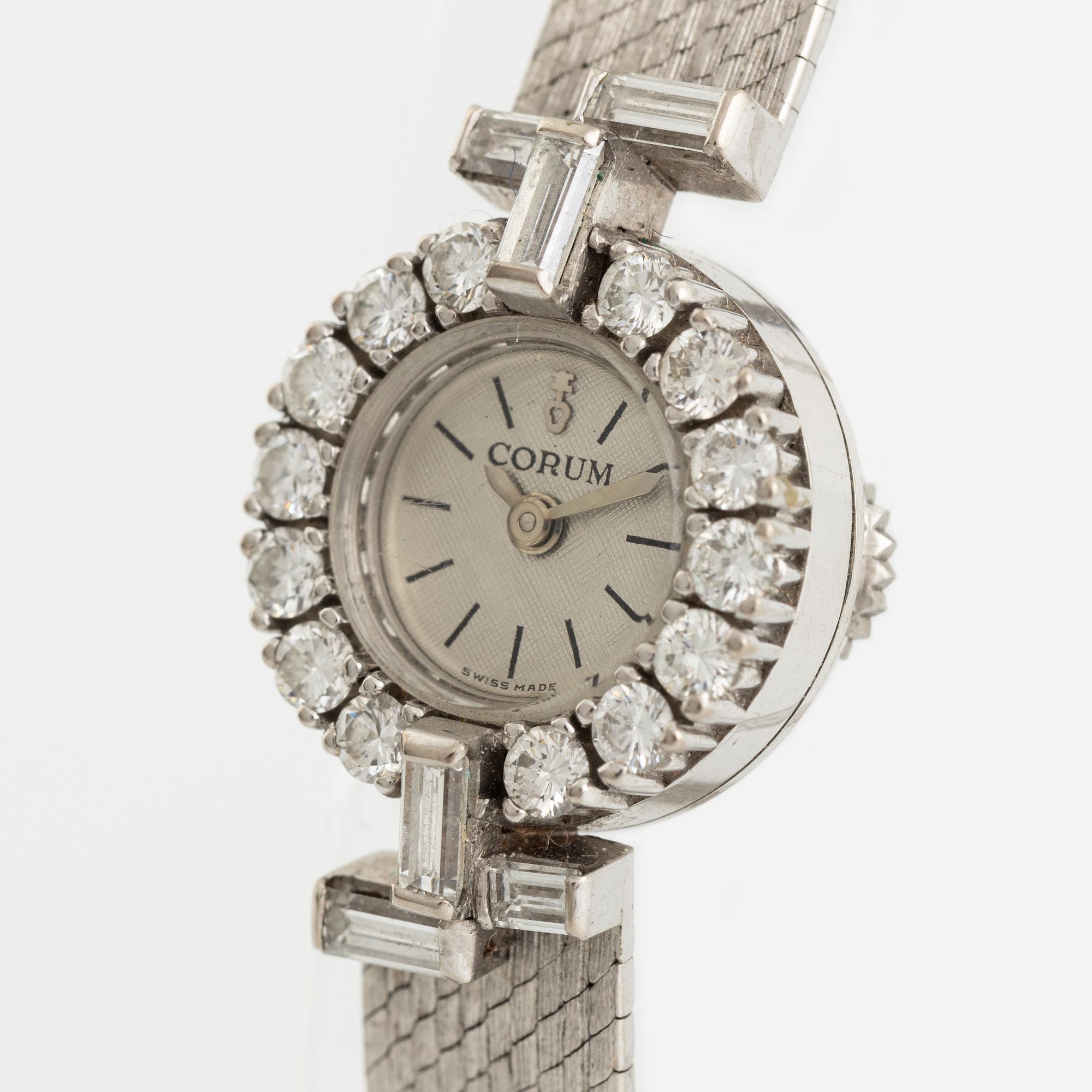 White gold, baguette- and brilliant cut diamond Corum ladies watch.