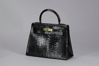 1307. A 1960s/70s black alligator "Kelly" handbag by Hermès.