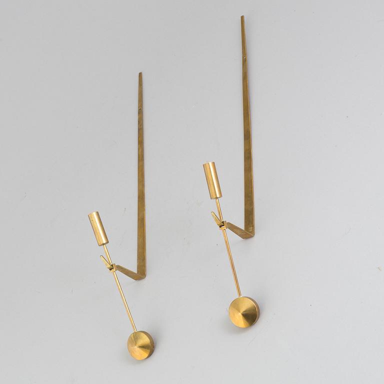 A pair of brass 'Pendeln' candleholders by Pierre Forsell, Skultuna.