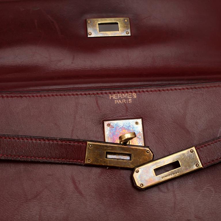 HERMÈS, a burgundy read leather "Kelly 32" bag, 1960's.