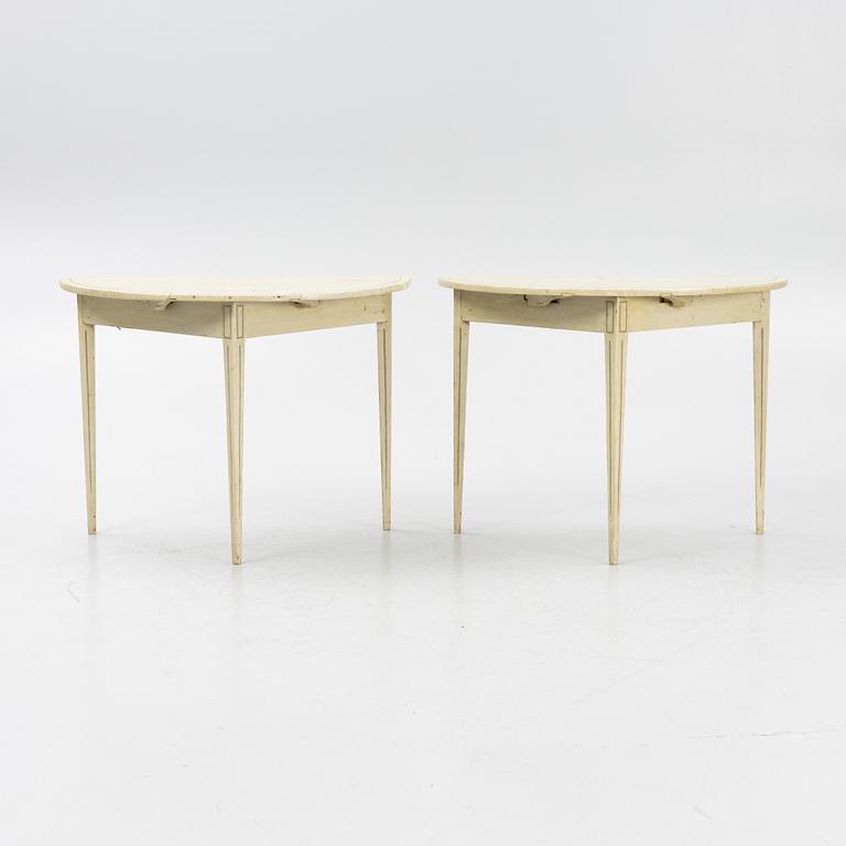 A pair of crescent-shaped tables, around 1900.