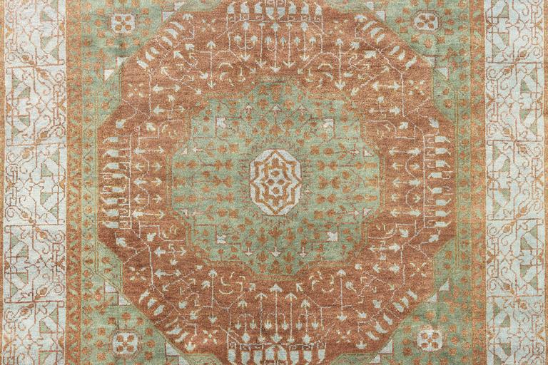 An oriental carpet with Mamluk design, c. 358 x 281 cm.