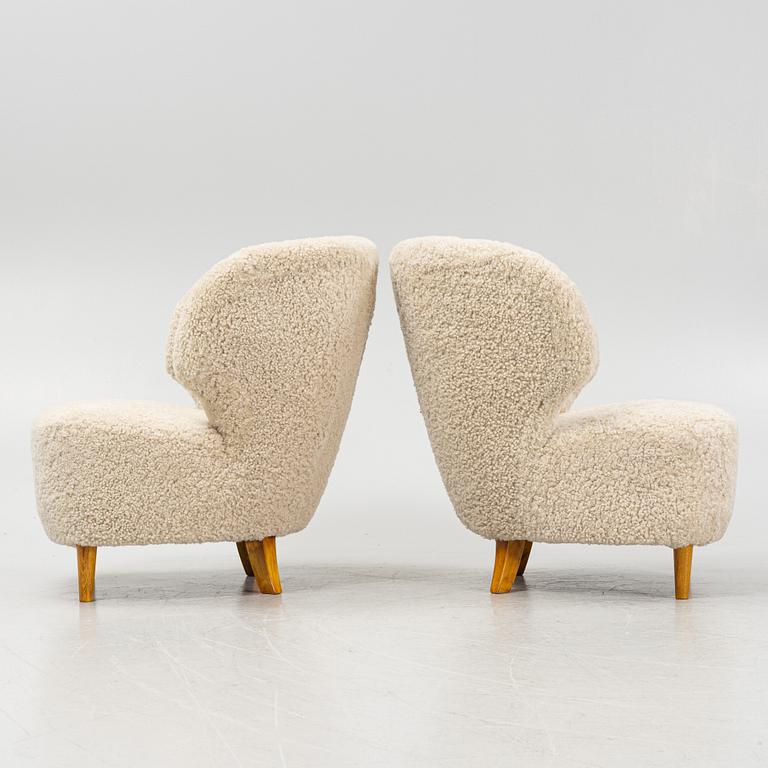 A pair of Scandinavian Modern 1940s cheepskin armchairs.