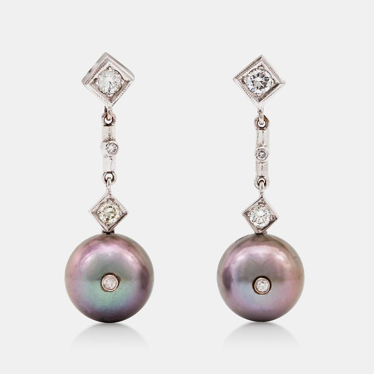 A pair of cultured Tahiti pearl and diamond earrings.