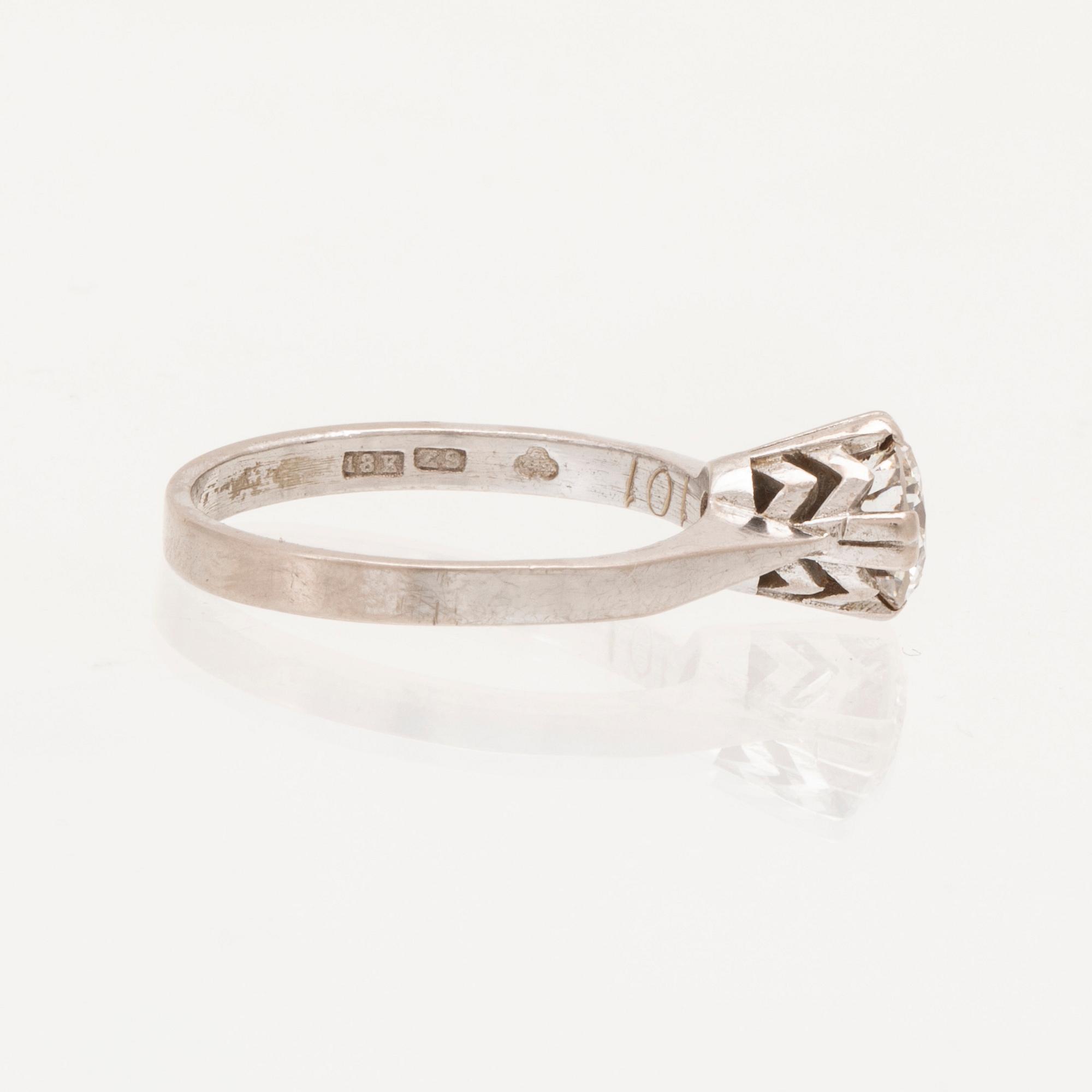 An 18K white gold solitaire ring set with a round brilliant cut diamond.