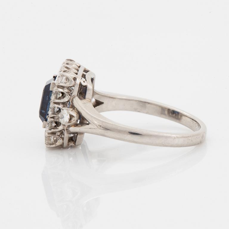 A platinum ring set with a faceted sapphire.