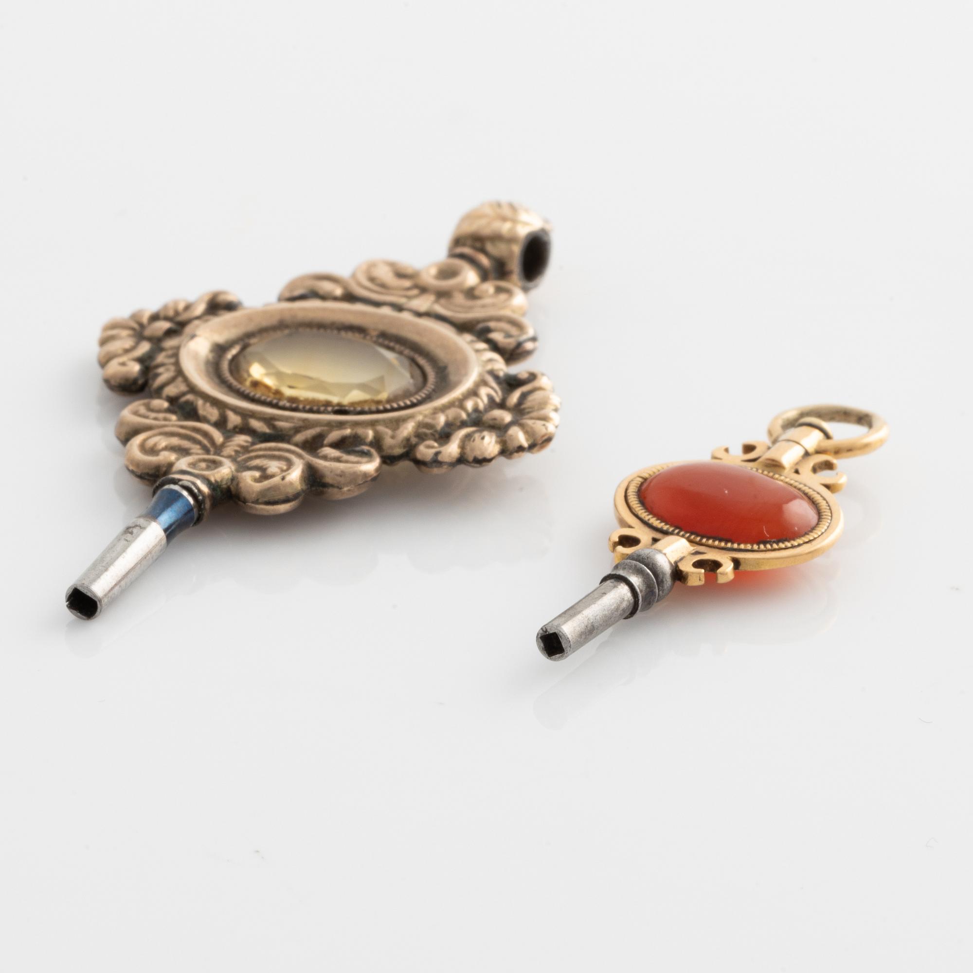 Two pocket watch key winders, gold, citrine and carnelian, 19th century.