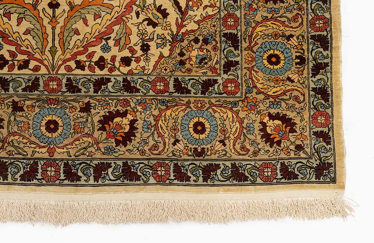 A semi-antique silk Hereke rug, c. 155 x 103 cm.