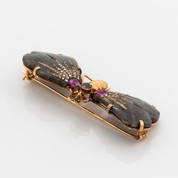 A butterfly brooch in 14K gold set with labradorite, rubies, rose-cut diamonds and garnets.