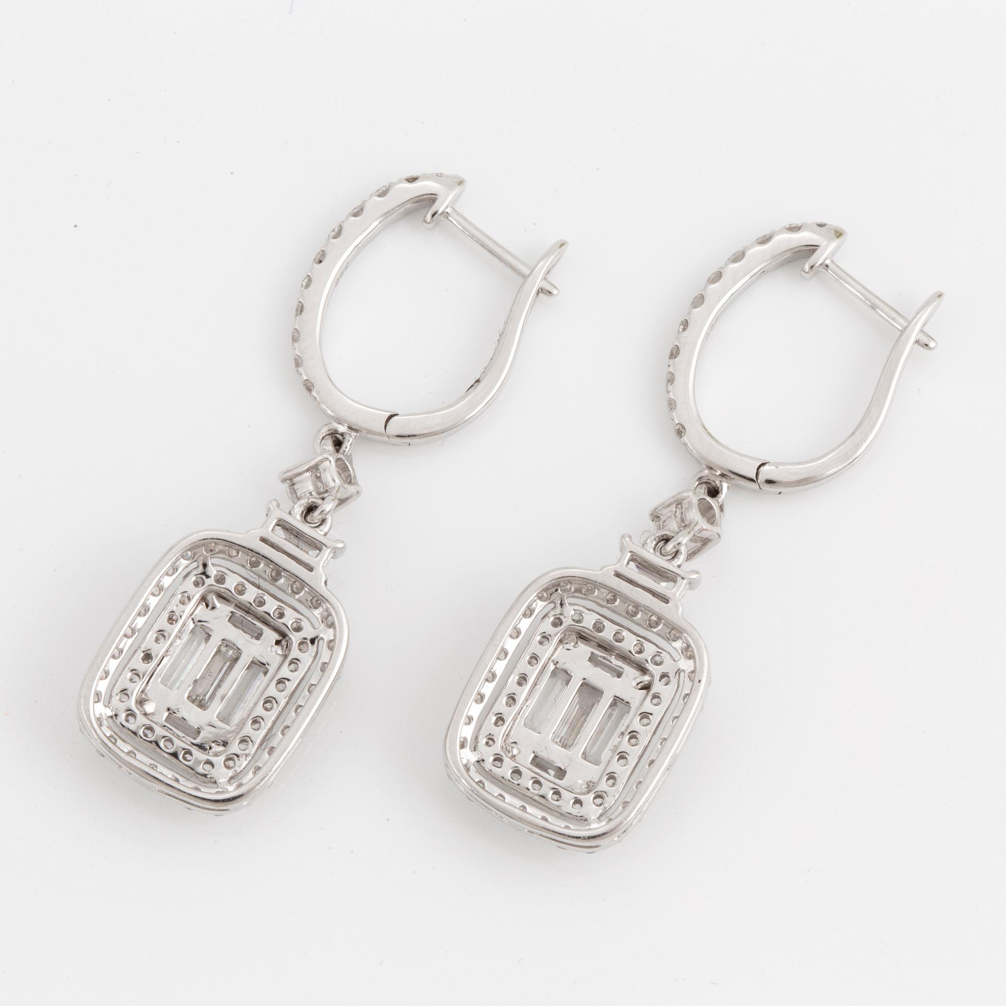 A pair of baguette and brilliant-cut diamond earrings.