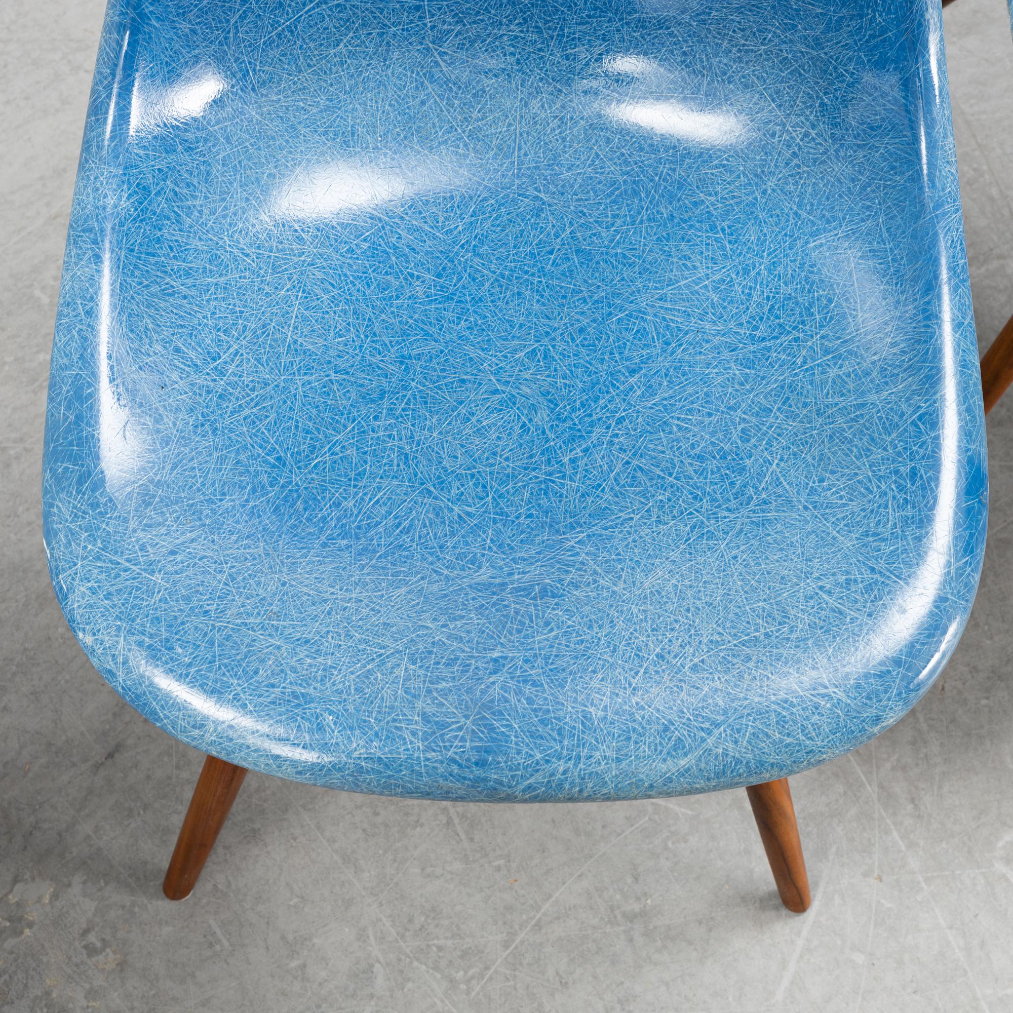 A set of four Charles and Ray Eames 'Plastic Chair DSW' with later stands, designed 1950.