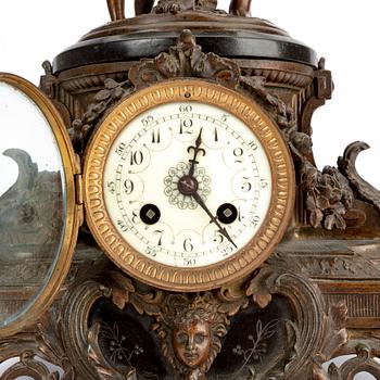 A metal table clock around 1900.