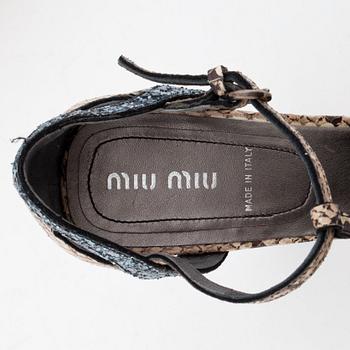 MIU MIU, a pair of snake skin embossed leather and glitter sandals.