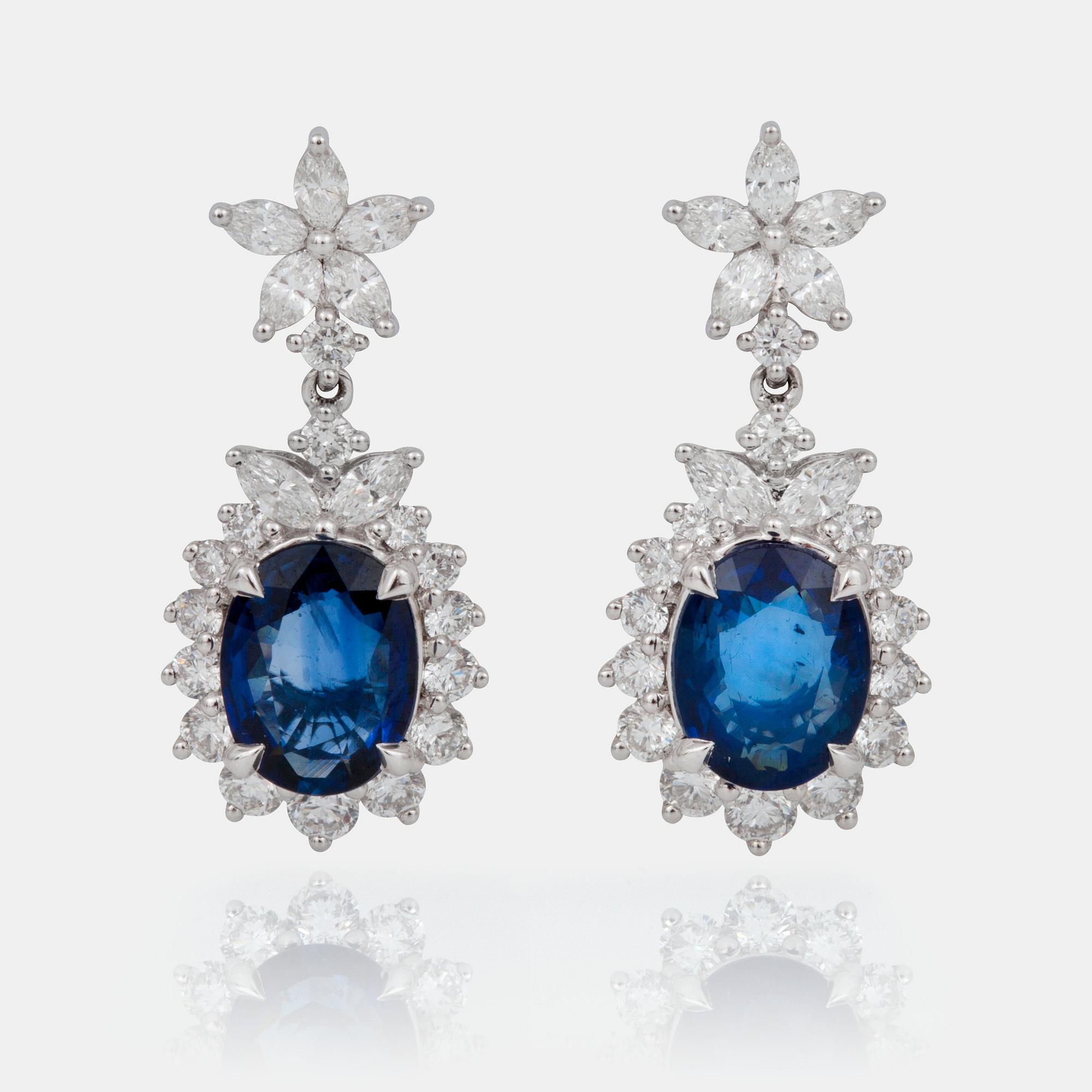 A pair of sapphire and diamond earrings.