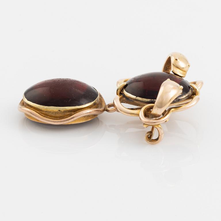 A 19th century 14K gold and garnet brooch with a detachable locket.