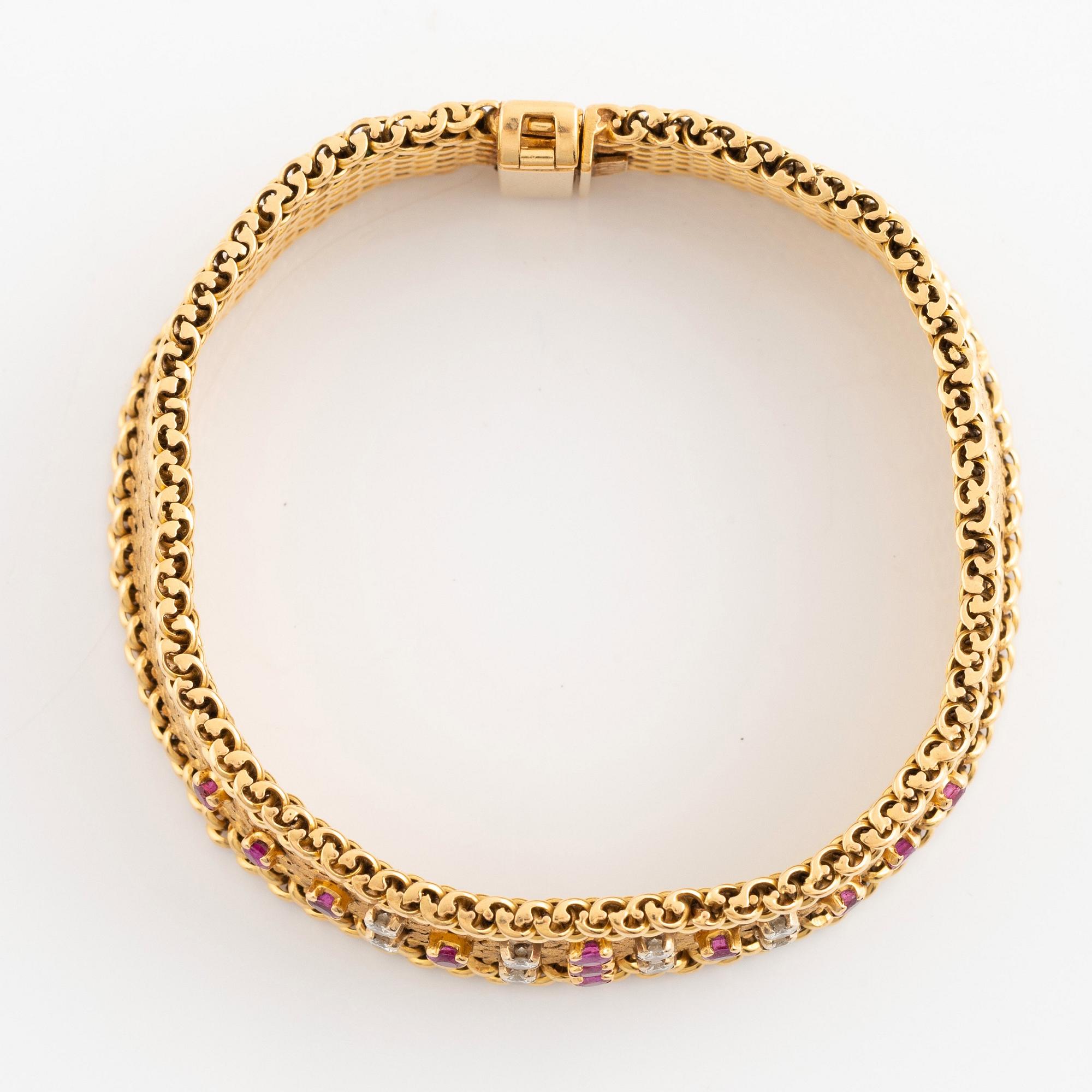 An 18K gold bracelet set with round brilliant-cut diamonds and rubies.