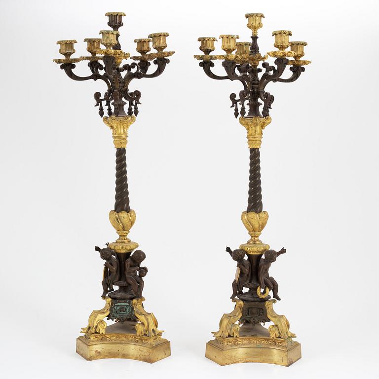 A pair of patinated bronze and ormolu neo-renaissance six-light candelabra, later part of the 19th Century.