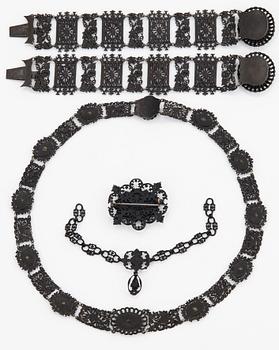 A Berlin steel and iron parure comprising a necklace, two bracelets and a brooch.