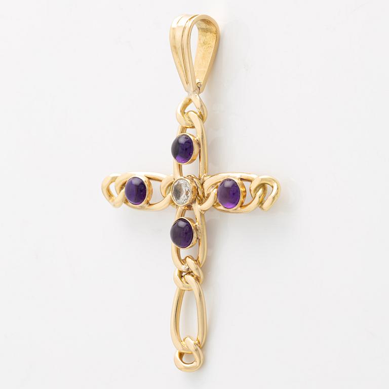 A cross in 18K gold with cabochon-cut amethysts and a white stone.