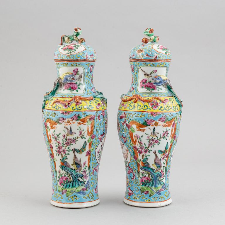 A pair of famille rose canton porcelain vases with covers, Qing dynasty, late 19th century.