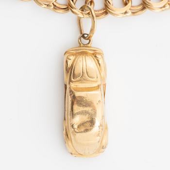 Bracelet, 18K gold bismarck link. With charms.