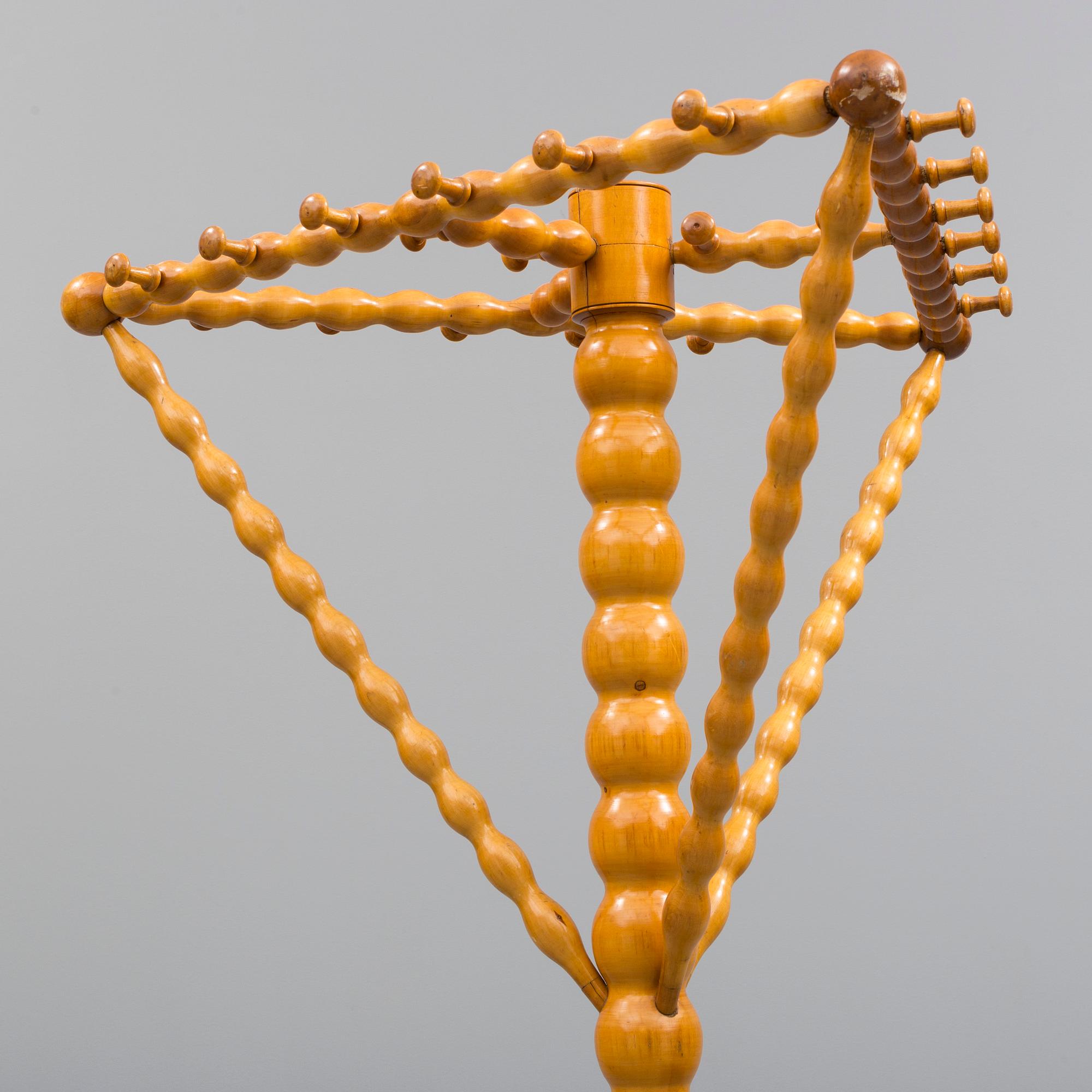 A turned birch clothes hanger, circa 1900.
