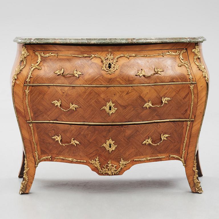 A rococo parquetry and gilt brass-mounted commode by J. J. Eisenbletter (active ca 1760-1810).