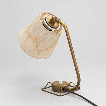 A mid-20th-century table lamp
/wall light for Idman.