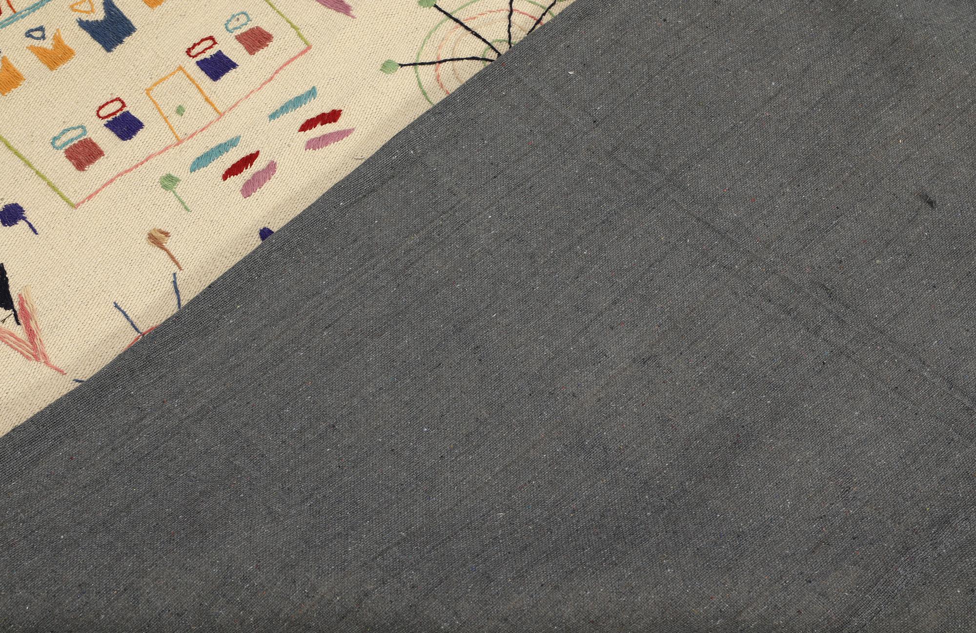 A hand-embroidered Kilim rug, approx. 244 x 180 cm.