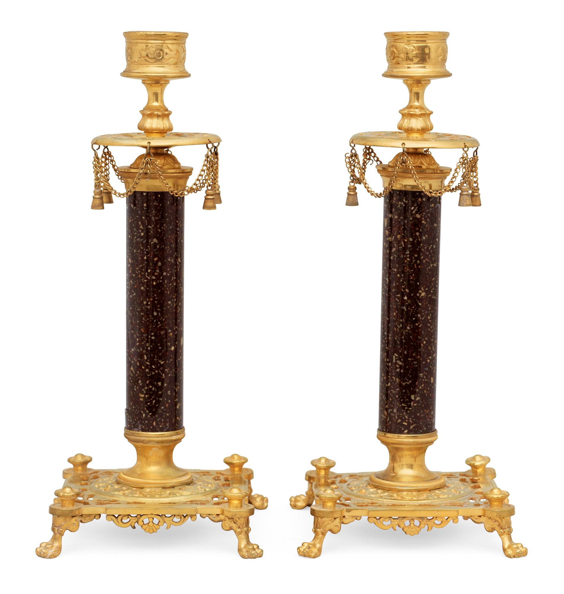 A pair of Swedish late 19th century brass and porphyry-imitation glass candlesticks.
