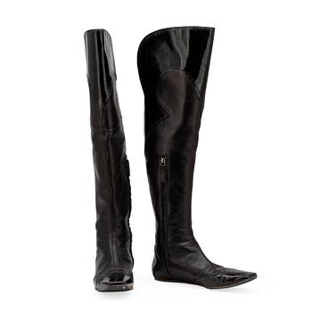 ALEXANDER MCQUEEN, a pair of black leather thigh high boots.