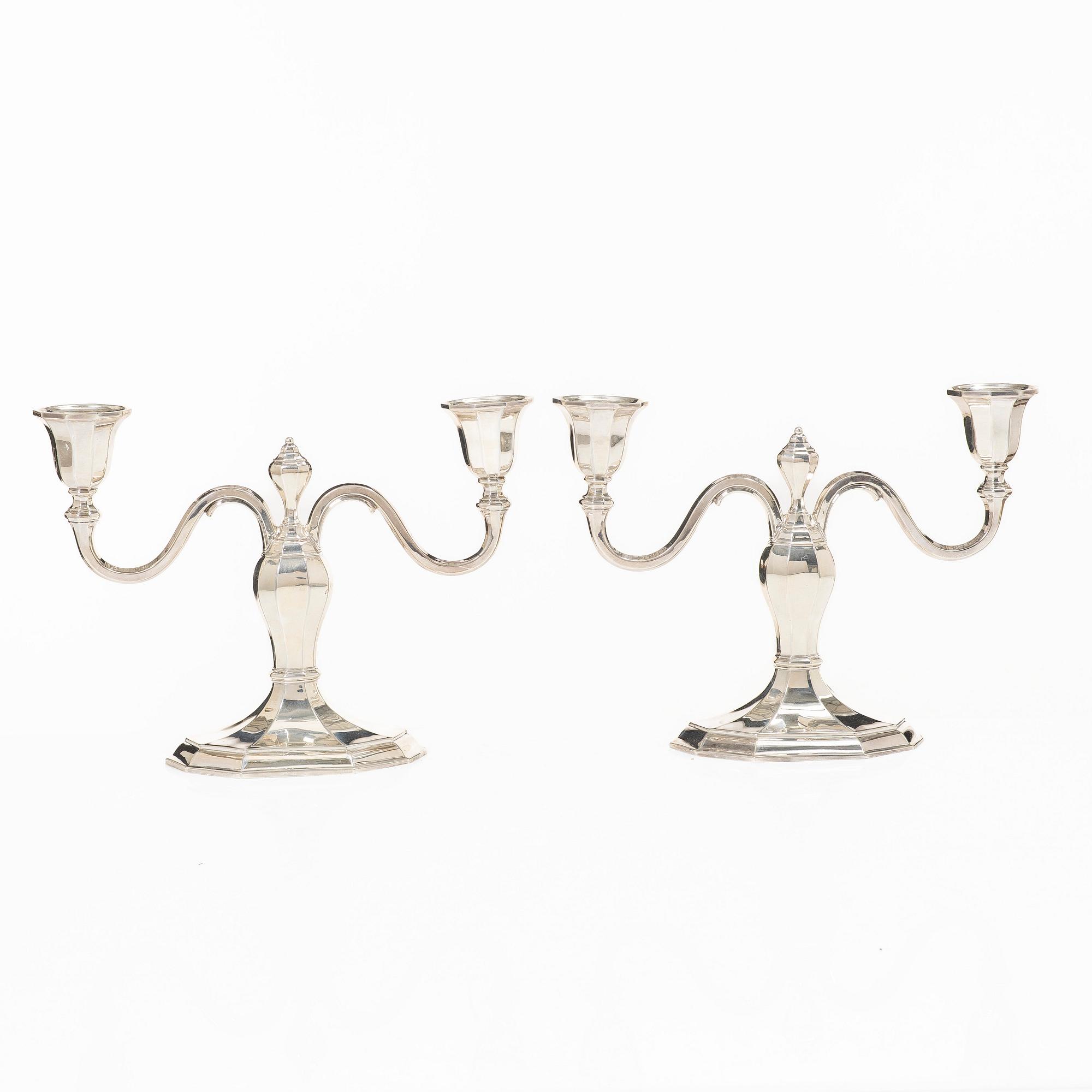 A pair of silver candelabras, with Swedish import marks, possibly mid20th century.