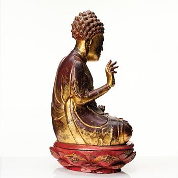 A large gilt and lacquered figure of a seated buddha, Qing dynasty, 19th Century.