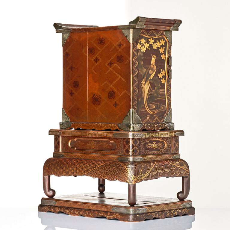 A Japanese lacquer cabinet on a stand, Meiji period (1868-1912).