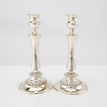 A pair of silver candlesticks with Swedish import stamps.
