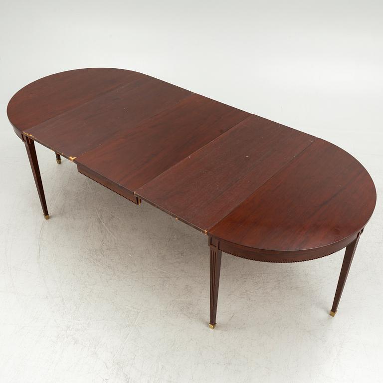 An Empire style dining table and ten chairs, second half of the 20th Century.