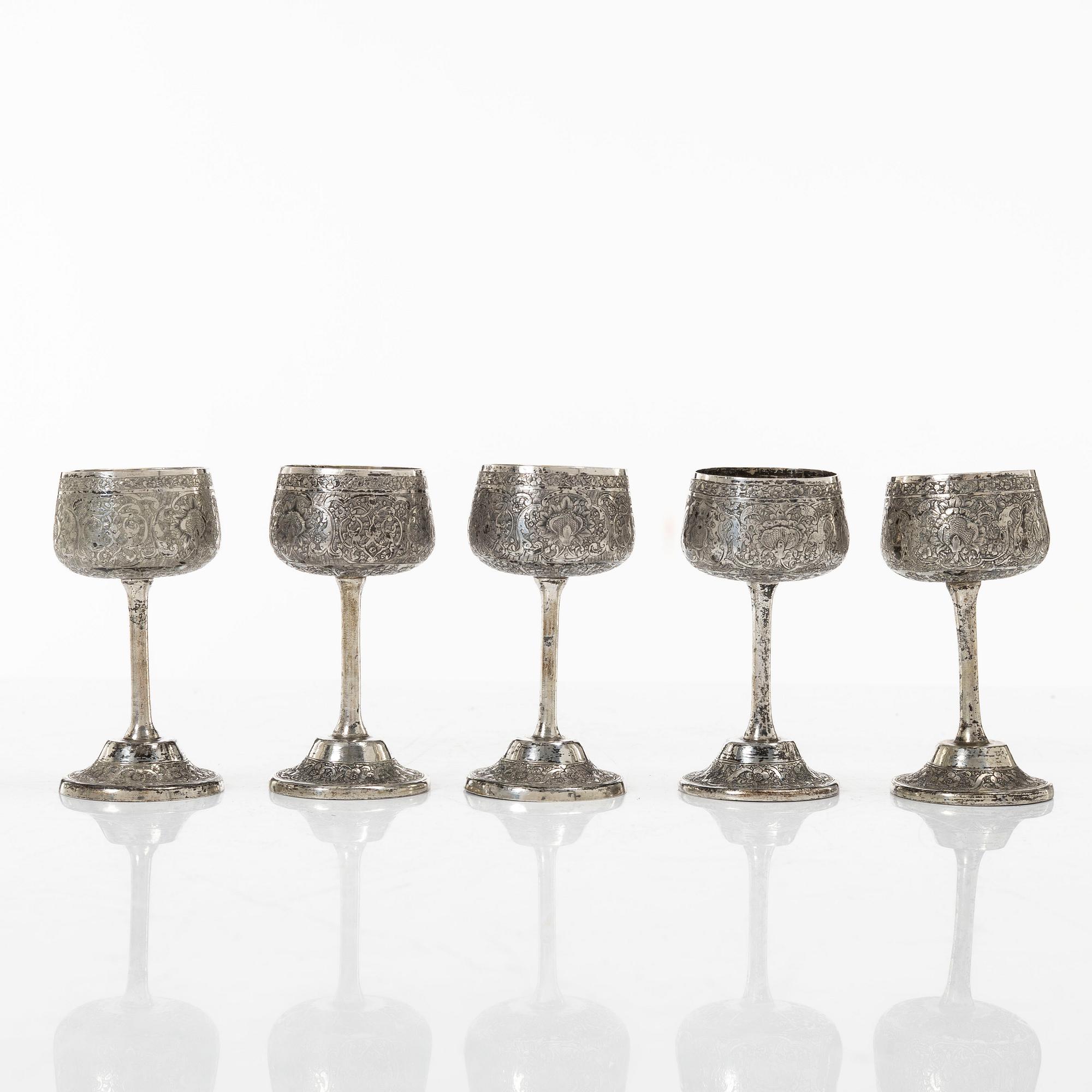 A Persian silver pitcher with five stemmed cups and a beaker, first part of the 1900s.