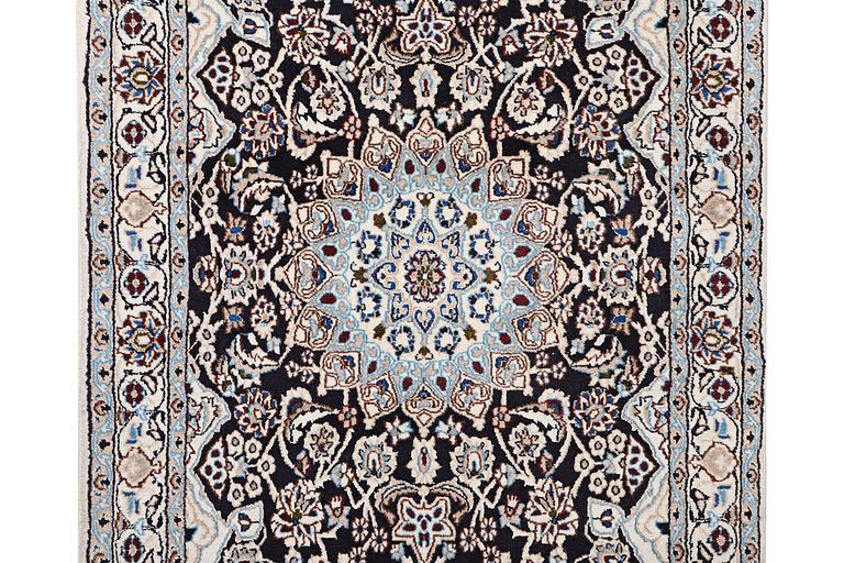 A Nain rug, part silk, 9 laa, c. 210 x 119 cm.