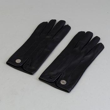 A pair of black lambskin gloves by Hermès.