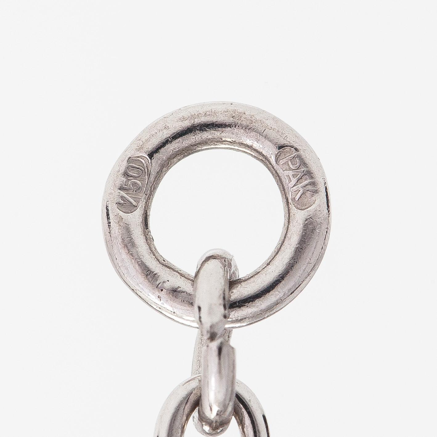 An 18K whitegold necklace with a diamond ca 1.01 ct, smaller diamonds tot. ca 0.15 ct, ruby and 
sapphires, Helsinki.