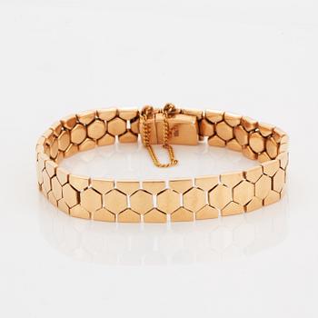An 18K gold bracelet.