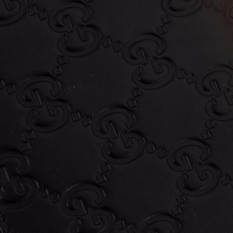Gucci, an embossed böack leather wallet.