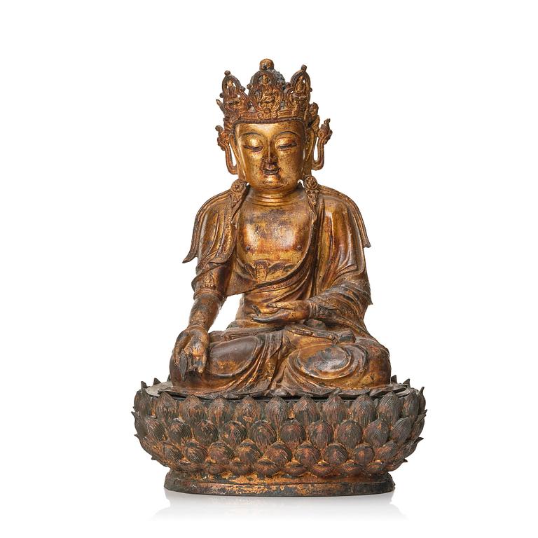 A large cold gilt sculpture of a crowned medicine Buddha/Bhaisjyaguru, Ming dynasty (1368-1644).